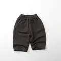 Detailed close-up of dark grey cotton kids casual pants featuring elastic waistband and pockets - 80cm / Dark Gray
