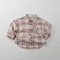 Detail of soft cotton plaid shirt showing buttoned chest pocket and textured fabric - 80cm / Apricot Pink Plaid