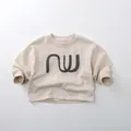 Detailed view of kids' cream long-sleeve sweatshirt with grey NW print and ribbed cuffs - 80cm / Warm Apricot