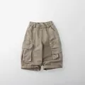 Detail view of khaki cotton cargo pants with elastic waist and large flap pockets - 80cm / Khaki