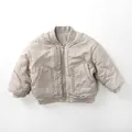 Detail of lightweight beige kids bomber jacket with ribbed collar and zipper pockets - 80cm / Apricot