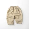 Detail view of elastic waistband and beige thick fabric texture on kids winter warm pants - 80cm / Light Khaki