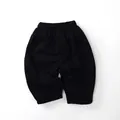 Detail of kids winter fleece-lined trousers with elastic waistband and black cotton fabric - 80cm / Black