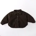 Detailed close-up of dark brown corduroy texture on thick padded kids winter shirt jacket - Brown / 80cm