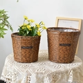 Close-up of woven straw plant pots with waterproof lining and leather label detail - Small / Inverted Cone
