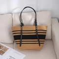 Light brown straw bucket bag with black stripes and leather straps on white sofa - 45*28 / Khaki and Black Striped