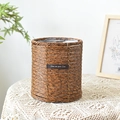 Brown woven rattan plant pot with plastic liner and leather label on white lace table - Straight Round Style