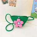 Green woven straw crossbody bag for girls featuring a large pink decorative flower - Style 2 Green