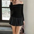 Detalle de top elegante con hombros descubiertos y textura de falda abullonada en modelo - S / Negro