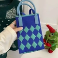 Detailed close-up of blue and green argyle knit phone bag with soft blue handle grip - Rhombus Pattern Royal Blue