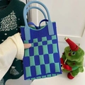 Close-up of heart pattern knitted small handbag with blue and green checkerboard texture - Checkerboard Royal Blue