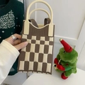 Close-up of knit tote bag featuring brown and beige checkerboard pattern and cream handle - Checkerboard Khaki
