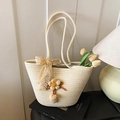 Cream-colored woven tote bag featuring a lace bow and a crochet floral charm detail - Off-White With Beige Flower And Ribbon
