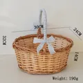 Detail view of woven wicker picnic basket with blue checkered bow and soft handle fabric - Oval Large (30cm) / Blue Checkerboard