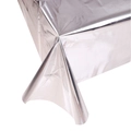 Close-up detail of silver metallic rectangle tablecloth with reflective foil texture - Silver