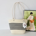 Woven straw tote bag in beige with black stripes and a cute plush bunny charm - Off-White And Black Striped And White Rabbit Charm