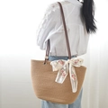 Brown woven tote bag with white lace bow and rose embroidery shown on shoulder - Khaki And Ribbon