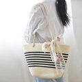 Beige woven tote bag with dark blue stripes and floral lace ribbon for summer beach vacation - Off-White And Black Striped And Ribbon