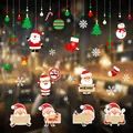 Macro detail of colorful Christmas window clings with Santa Claus and festive snowflake decals - HYC-62-65