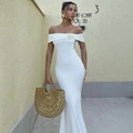 Detail of elegant white off-shoulder dress featuring a gold swirl metal ornament - S / White