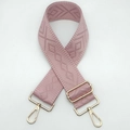 Close-up of pink geometric jacquard strap with polished light gold metal hardware clips - Sakura Pink