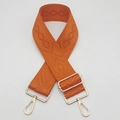Detailed close-up of orange geometric jacquard wide bag strap with gold metal hardware - Orange
