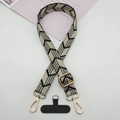 Close-up of black and white geometric arrow strap with gold metal hooks and phone patch - 款式五(带T型垫片)