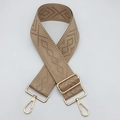 Close-up of a 5cm wide khaki geometric woven bag strap with golden metal swivel hooks - Camel