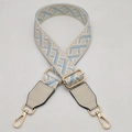 Detail of adjustable geometric jacquard bag strap with gold-tone rotating metal hooks - White Beige Blue + Off-white Leather