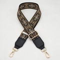 Detail of vintage ethnic style woven guitar strap for handbags with gold metal hardware - Black with Brown + Black Leather