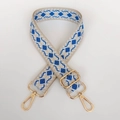 Detail of adjustable woven bag strap with blue geometric diamond pattern and gold metal hooks - Light Gold Hook / Beige White Blue