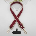 Detail view of woven geometric strap with golden metal hooks and black phone tether pad - Beige Edge Wine Red With T-Pad