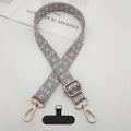 Detail of ethnic jacquard phone strap with golden clasp and black tether tab - Pink Edge Grey With T-Pad