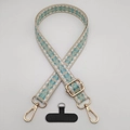 Detailed view of vintage diamond pattern crossbody strap with gold metal lobster clasps - Beige White Water Green