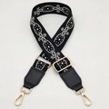 Detailed view of woven black and white ethnic purse strap with gold metal lobster clasps - Black White + Black Leather