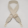 Detail of adjustable cream wide strap with floral jacquard pattern and gold metal buckles - Beige + Beige Leather