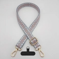 Detail of adjustable wide woven phone strap with geometric jacquard pattern and gold hooks - Gray White Pink