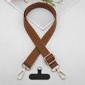 Close-up of brown geometric jacquard phone strap with gold hooks and black connector pad - Solid Brown With T-Pad