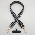 Detail of adjustable woven phone strap with vintage geometric patterns and gold metal clips - Black White Grey