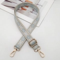 Detail of blue geometric embroidered bag strap with light gold metal swivel hooks - Light Blue With Beige Base