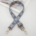 Detail of blue and beige ethnic geometric embroidery on adjustable strap with gold buckles - Beige Lake Blue