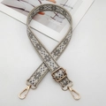 Close-up of ethnic geometric embroidered bag strap with light gold metal hardware - Beige with Grey
