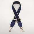 Close-up of ethnic style navy nylon bag strap with gold metal buckle and leather ends - Blue with Beige Edge