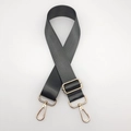 Detail of adjustable dark gray nylon shoulder strap with premium gold metal hardware - Dark Gray + Gold Hook