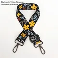 Detailed view of adjustable floral shoulder strap with black webbing and gunmetal hooks - Black and Yellow Flower / Gunmetal