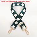 Close-up of adjustable dark green shoulder strap with daisy pattern and gold hooks - Green Flower / Gold