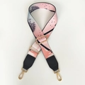 Close-up of adjustable strap with abstract print, leather ends, and gold metal hooks - Silver Hook / Graffiti + Black Leather