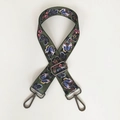 Close-up of olive green canvas bag strap with colorful butterfly prints and metal hooks - Butterfly Print With Gunmetal Hook