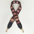 Close-up of ethnic geometric pattern strap with gold metal hooks and black leather ends - Red Diamond + Black Leather