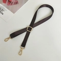 Detail view of dark coffee nylon strap with polished gold metal lobster clasps and buckle - Brown